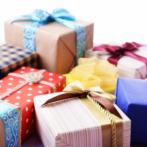Assorted colorful gift boxes with ribbons on a white background