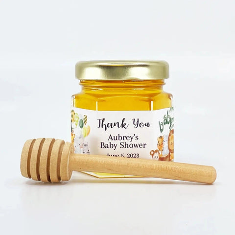 Jar of honey with a wooden dipper on a white background, featuring a personalized label.