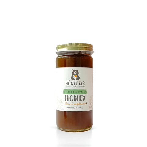 Jar of honey with a label on a white background