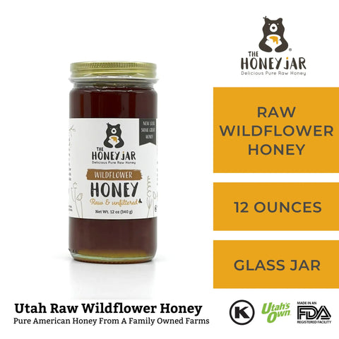 Jar of raw wildflower honey with The Honey Jar branding on a white background