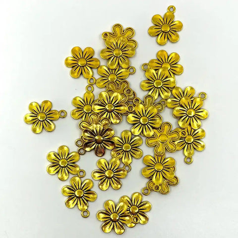 Gold flower-shaped charms on a white background