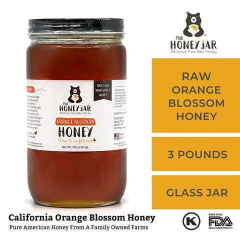 Jar of raw orange blossom honey with The Honey Jar branding on a white background
