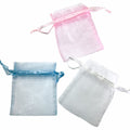 Three organza bags in pink, blue, and clear on a white background