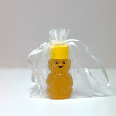 Honey bear bottle in a transparent white bag on a white background