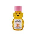 Bear-shaped honey bottle with pink cap and personalized label on a white background
