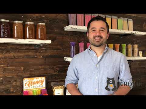Video of man standing in front of various honey products on shelves explaining how to open a honey stick