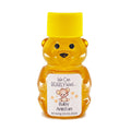 Bear-shaped honey bottle with a yellow cap and personalized label on a white background