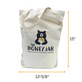 Canvas tote bag with 'The Honey Jar' logo and dimensions on a white background