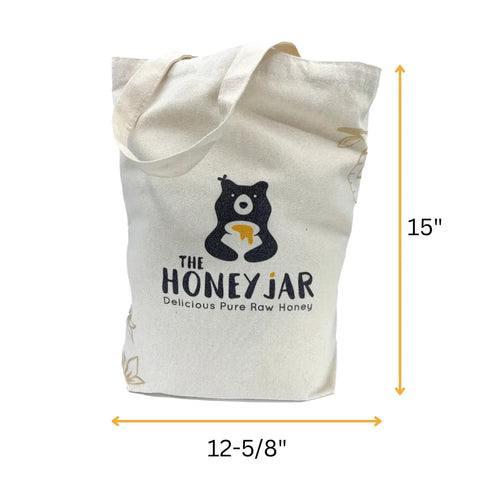 Canvas tote bag with 'The Honey Jar' logo and dimensions on a white background