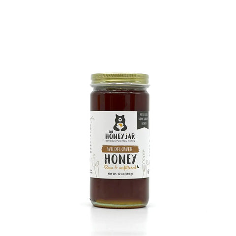 Jar of honey with a label on a white background