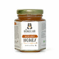 Jar of wildflower honey from The Honey Jar on a white background