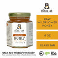 Jar of raw wildflower honey with 'The Honey Jar' branding on a white background