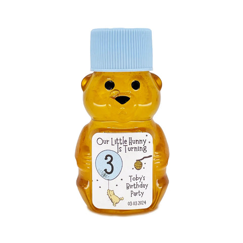 Honey bear bottle with a blue cap and personalized label on a white background