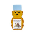 Honey bear bottle with a blue cap and personalized label on a white background