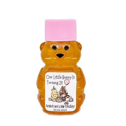Bear-shaped honey bottle with pink cap and personalized label on a white background