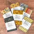 Collection of colorful beeswax food wraps on a wooden surface