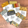Collection of colorful beeswax food wrap sheets on a wooden surface