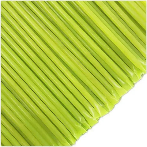 Close-up of green straws on a white background