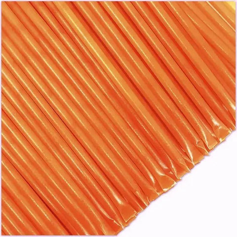 Close-up of orange honey sticks on a white background