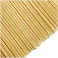 Close-up of pale yellow honey sticks on a white background