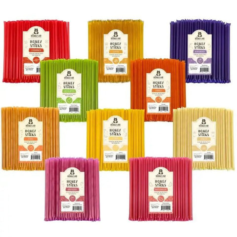 Assorted packages of honey sticks in various colors on a white background
