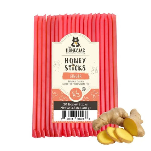 Pack of The Honey Jar ginger honey sticks with a small pile of ginger roots on a white background