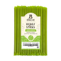 Pack of green honey sticks with a label on a white background