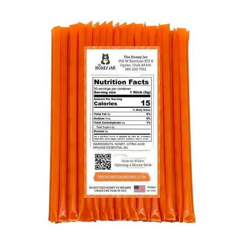 Pack of orange honey sticks with a nutrition facts label on a white background