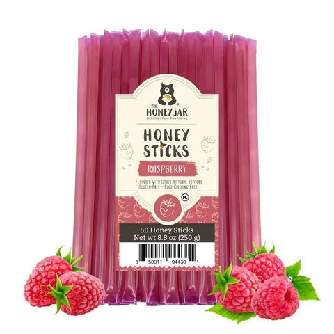 Pack of Raspberry Honey Sticks with packaging and raspberries on a white background
