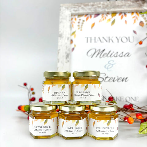 Jars of honey with personalized labels in front of a 'Thank You' sign and fall decorations.