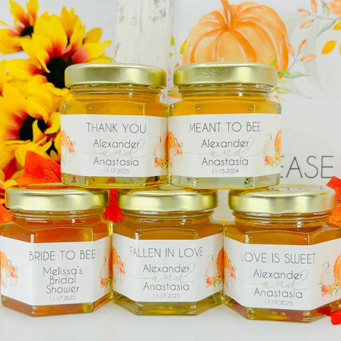 Jars of honey with personalized labels on a decorative background with flowers and pumpkins.