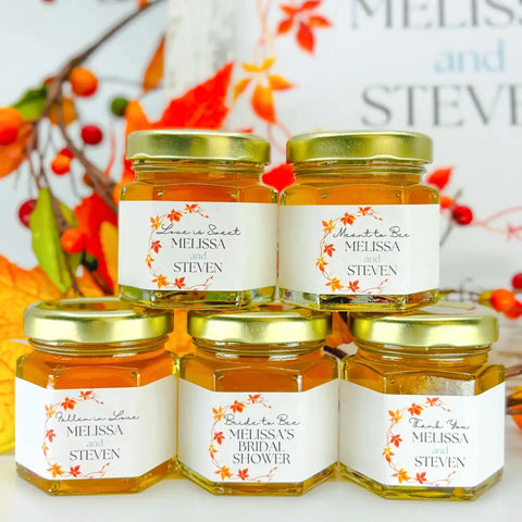 Jars of honey with personalized labels on a decorative background