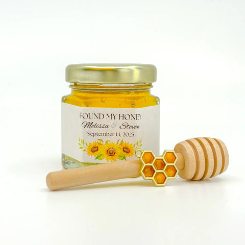 Honey jar with personalized label, enamel honeycomb charm, and wooden honey dipper on a white background