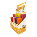 Display box of honey sticks with colorful packaging on a white background