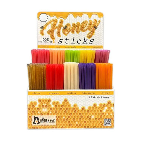 Packaged honey sticks with colorful packaging on a white background