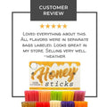  Colorful honey sticks below a customer review on white background