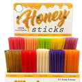 Display of honey sticks with colorful packaging and labels.