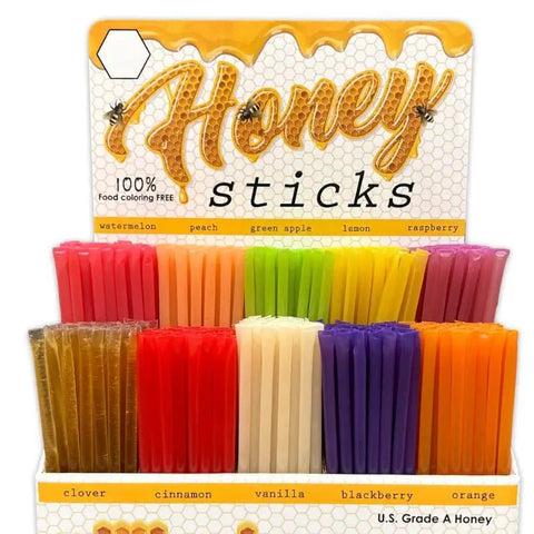 Display of honey sticks with colorful packaging and labels.